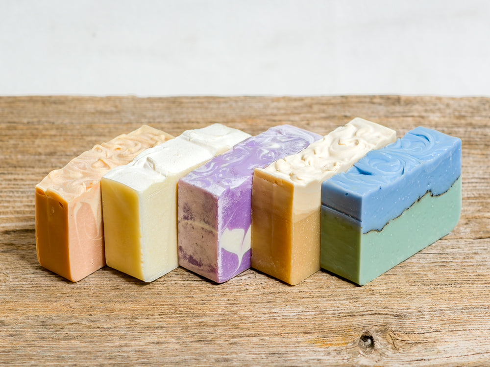 Purple, beige and orange bars of soaps stacked next to each other