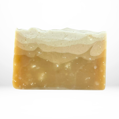 Bar of the 'Let's Meet In Town' orange colored soap on a white background with no packaging