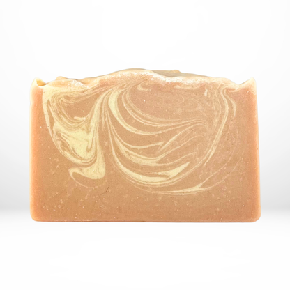 Bar of the 'Sunny Valley Farm' orange and yellow marble colored soap on a white background with no packaging
