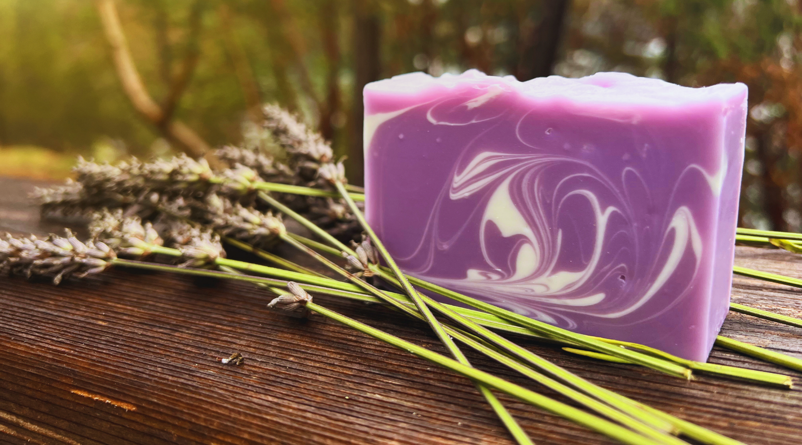 Bar of Lavender Sachet Soap with gentle swirl pattern and several lavender stems