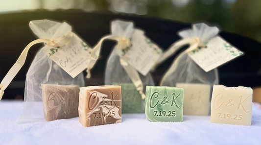 Personalized wedding soap bars with 'C&K' and a date, wrapped in sheer bags.